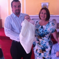 Layla Faith with her parents on her baptism day.