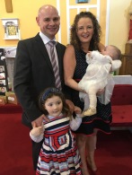 Emma Mary Saoirse Flynn with her parents Caitriona and Derek and sister Katie on her baptism day.